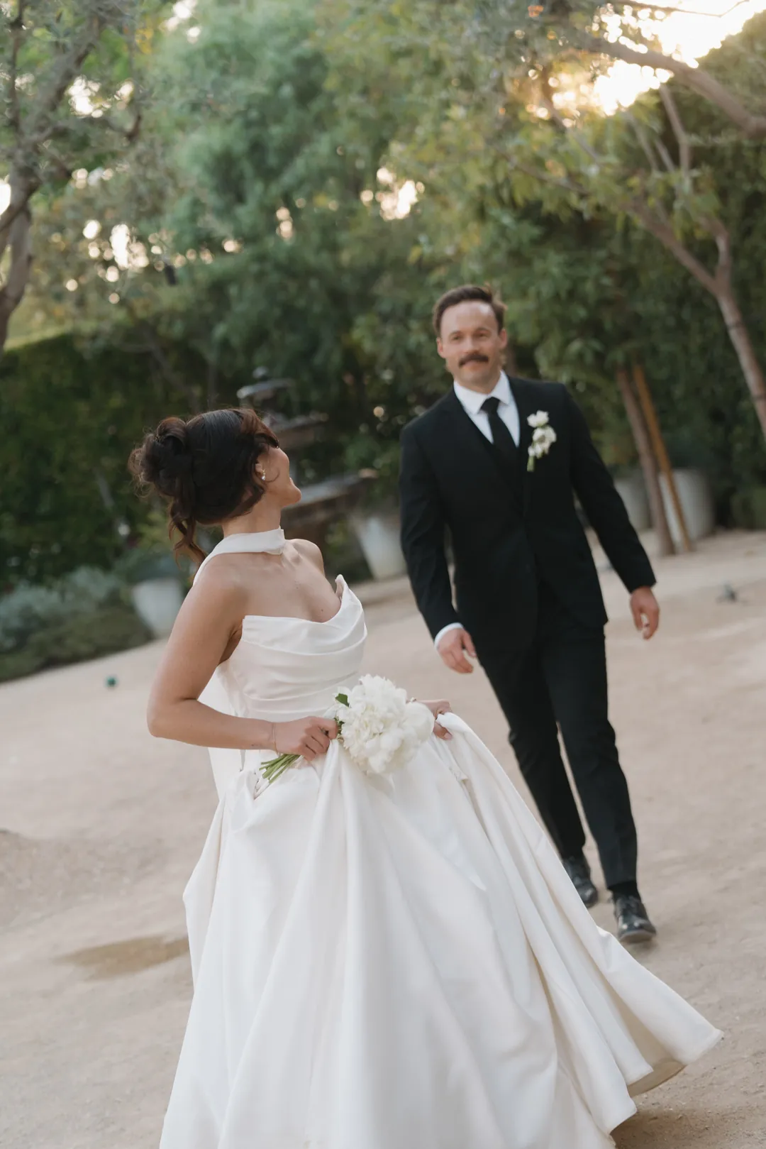 Bride and groom pose for golden hour romantics.