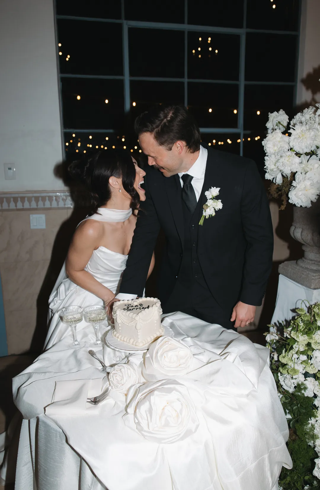 Bride and groom cut into vintage heart wedding cake.