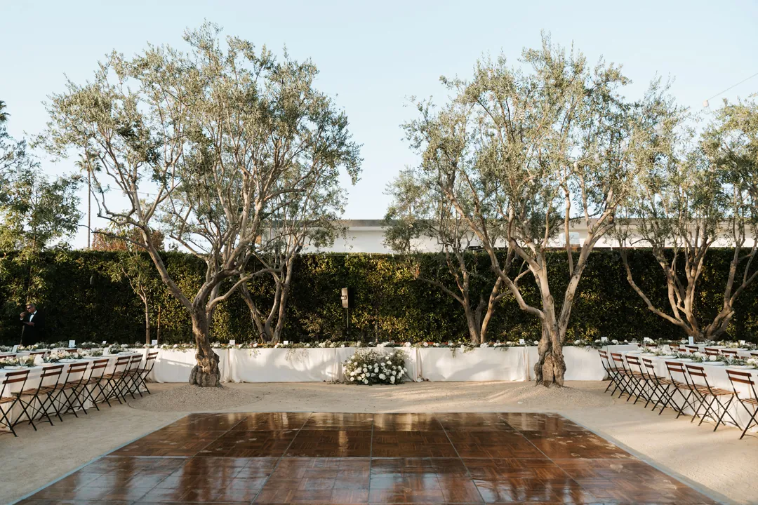 An al fresco wedding reception is set in the outdoor courtyard.