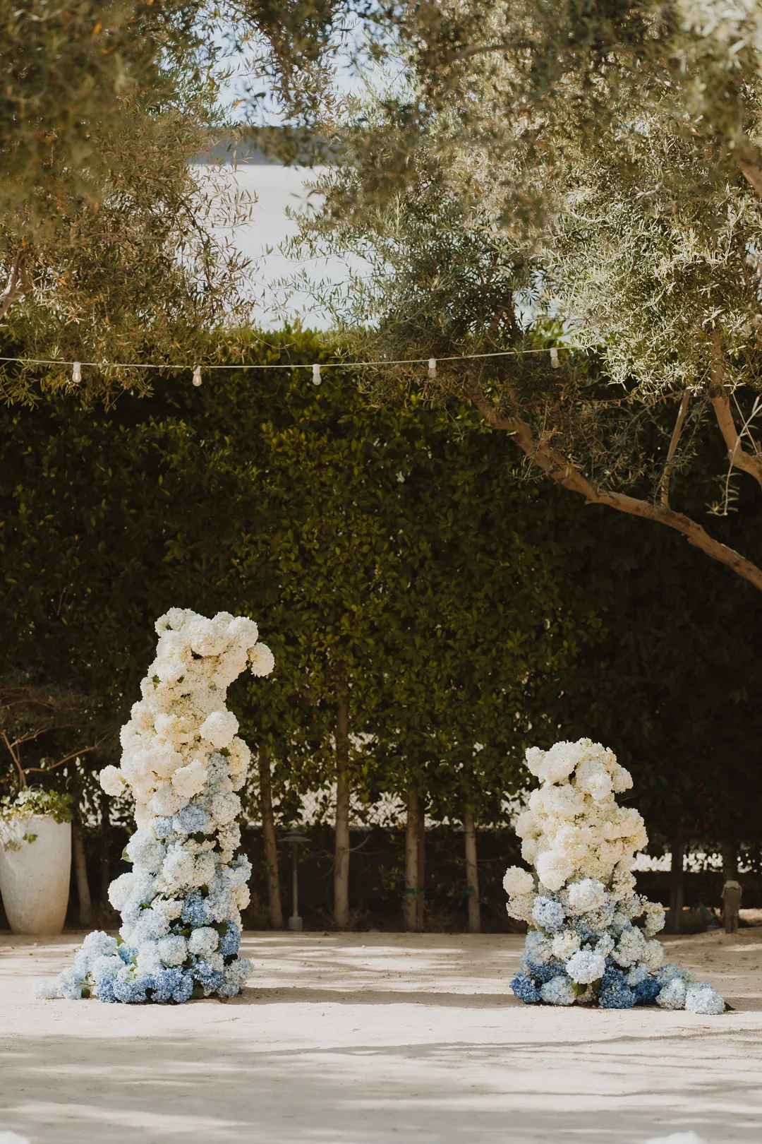 Ceremony backdrop with white and pale blue flowers