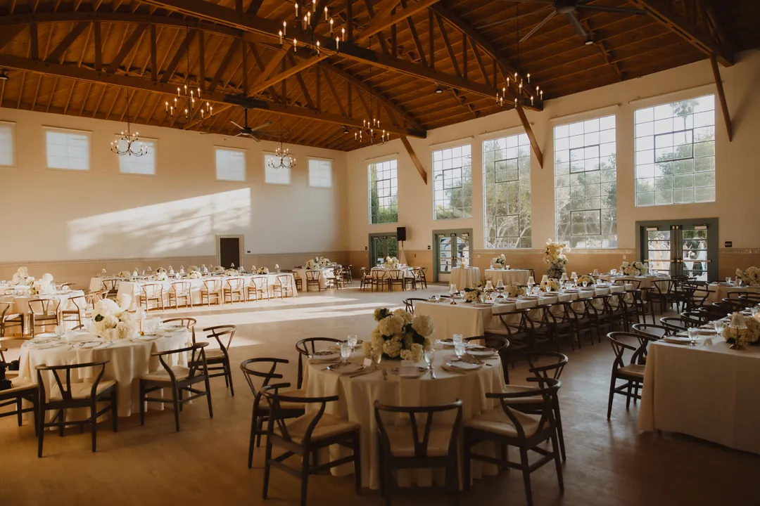 Reception hall filled with flower-decorated dining tables