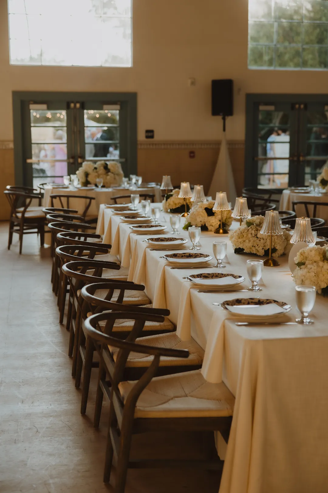 Long reception table with plates and crystal glassware