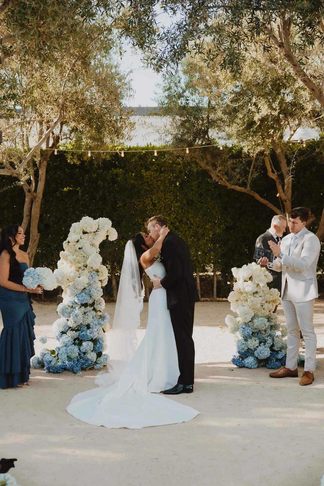 Bride and groom kissing at their outdoor ceremony