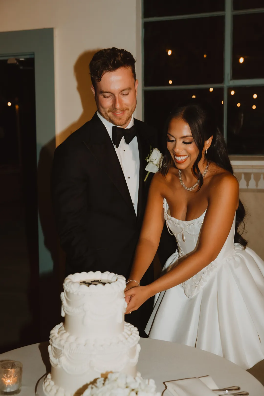 Bride and groom cutting their wedding cake