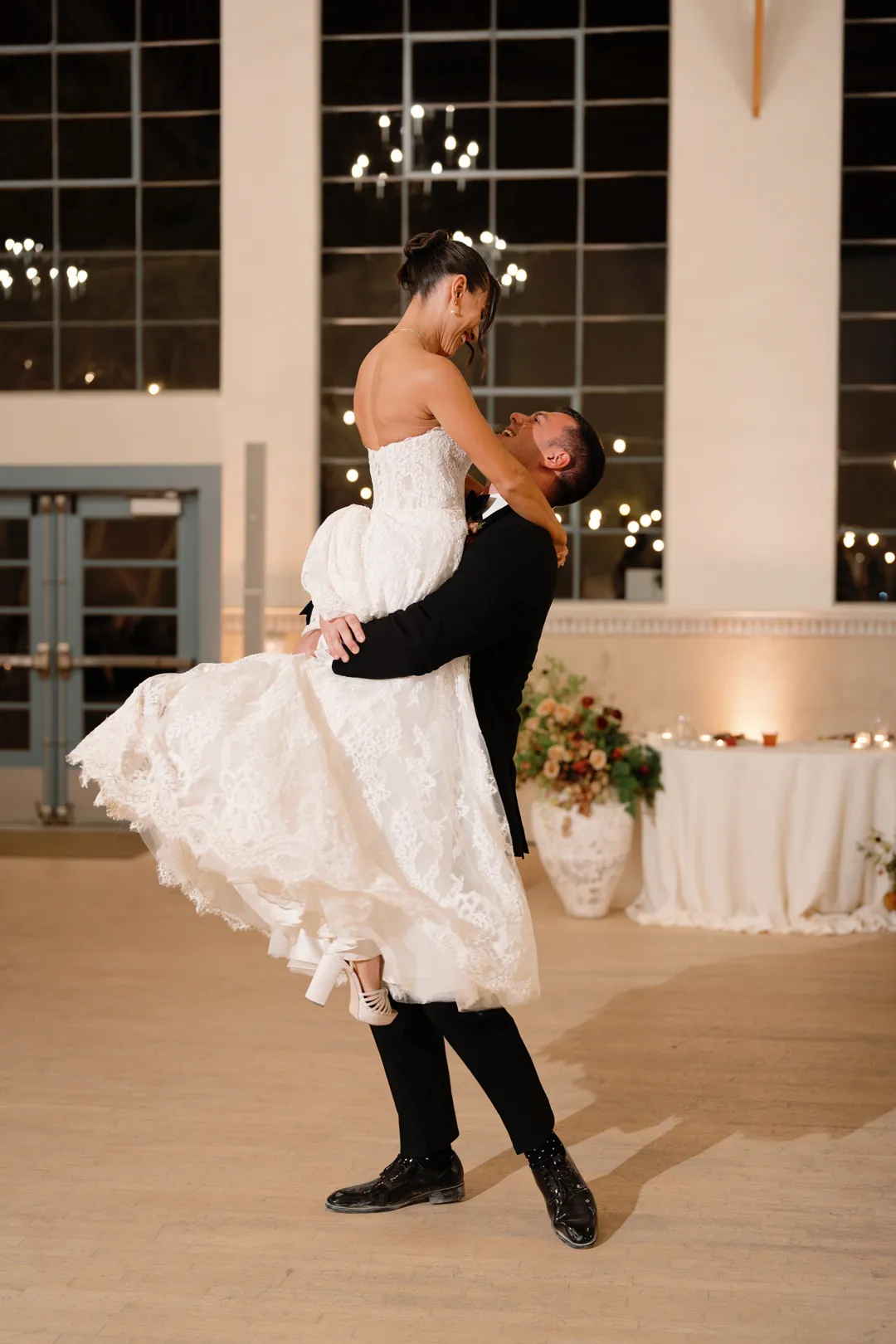 Groom lifting the bride during their first dance