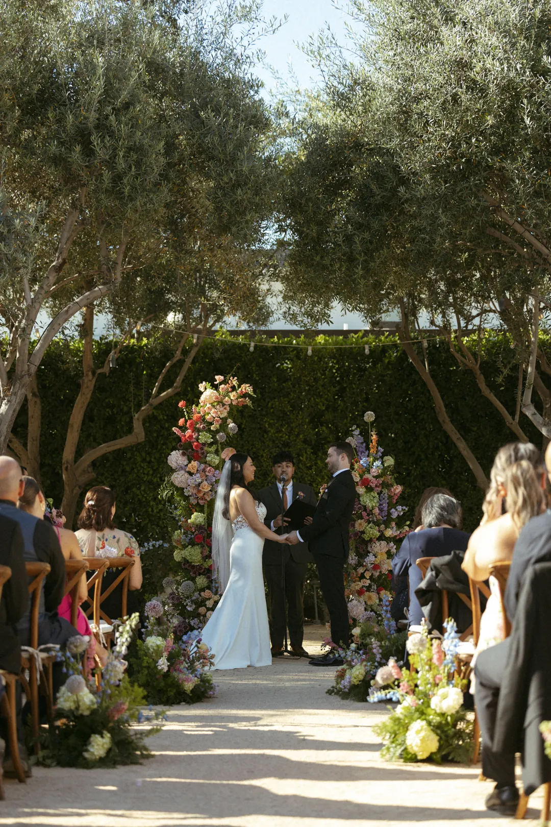 Guests watching the couple during a courtyard wedding ceremony