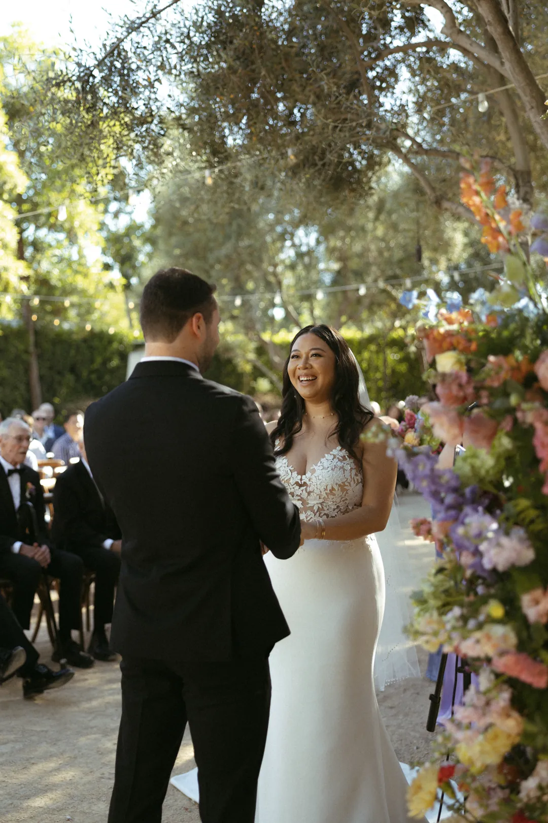 Bride smiling at the groom during their outdoor ceremony
