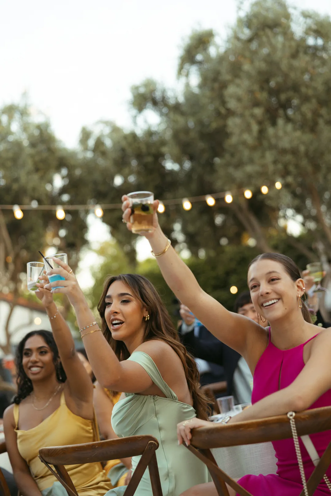 Guests raising drinks together in a toast