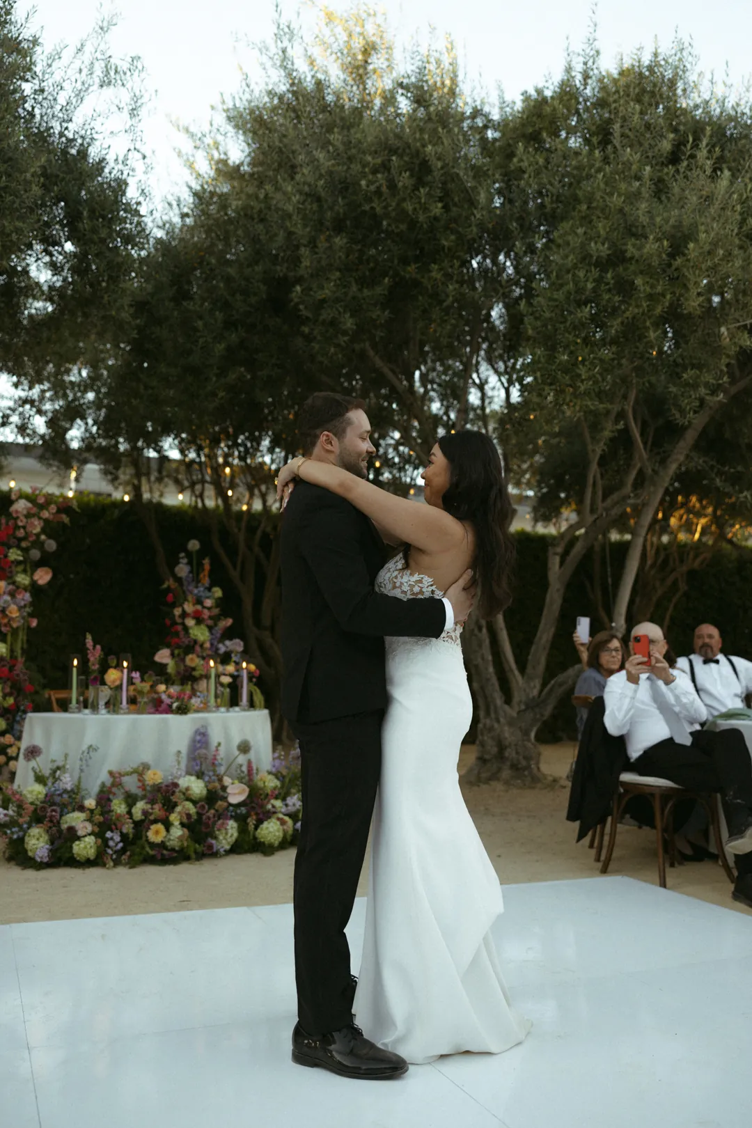 Bride and groom embracing on the outdoor dance floor