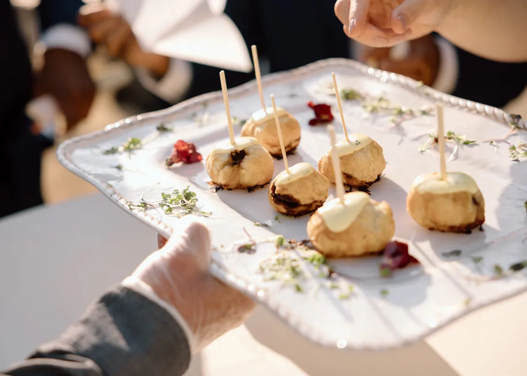 Guest taking an appetizer from a serving tray