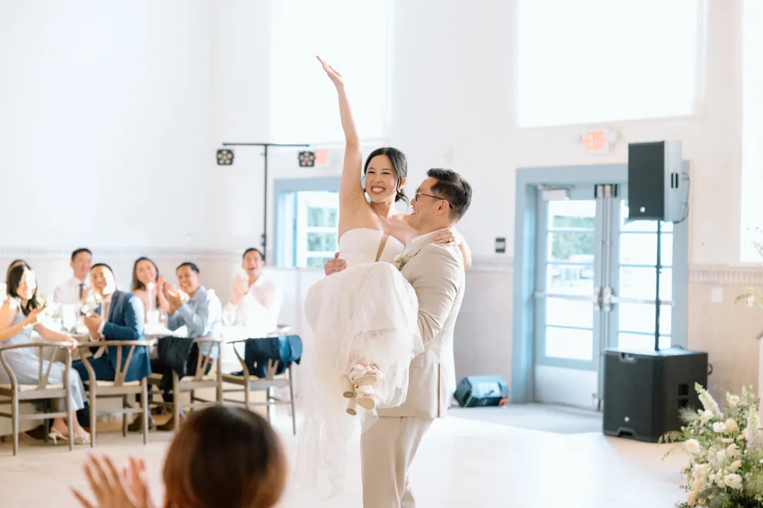 Groom lifting the bride during their first dance