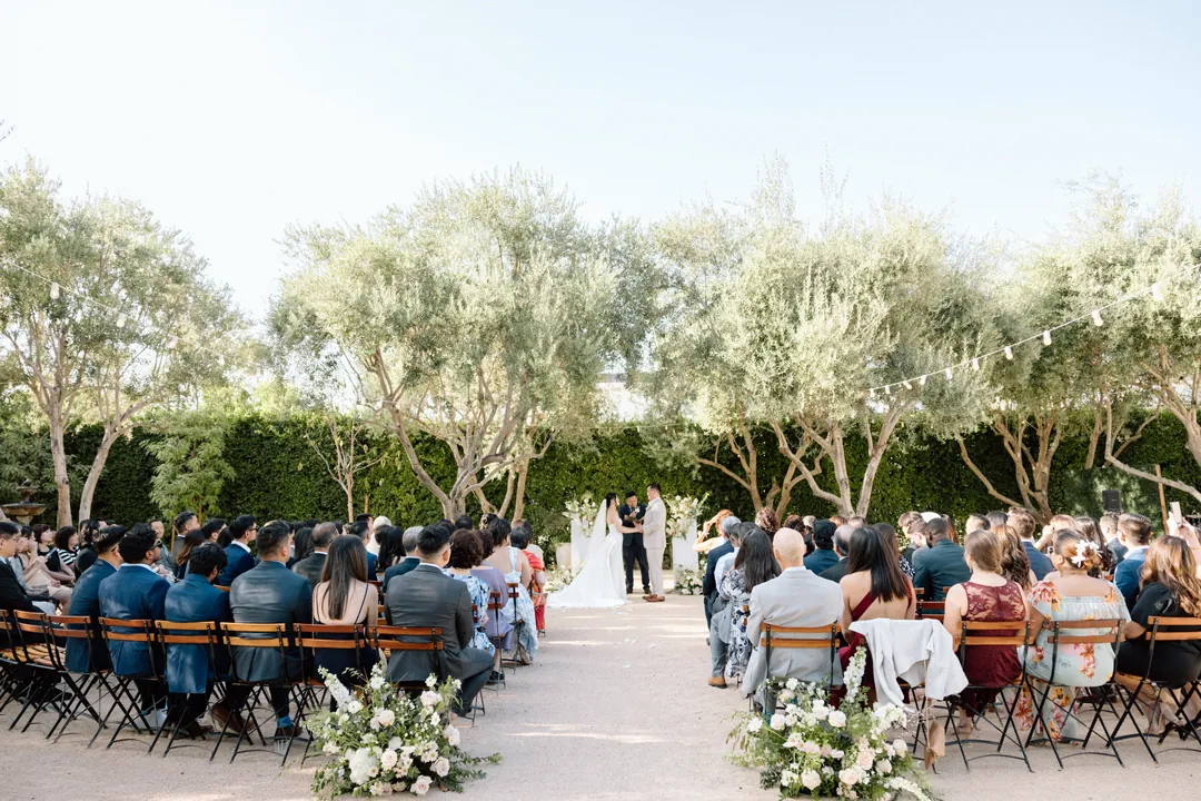 Guests seated around the outdoor ceremony aisle