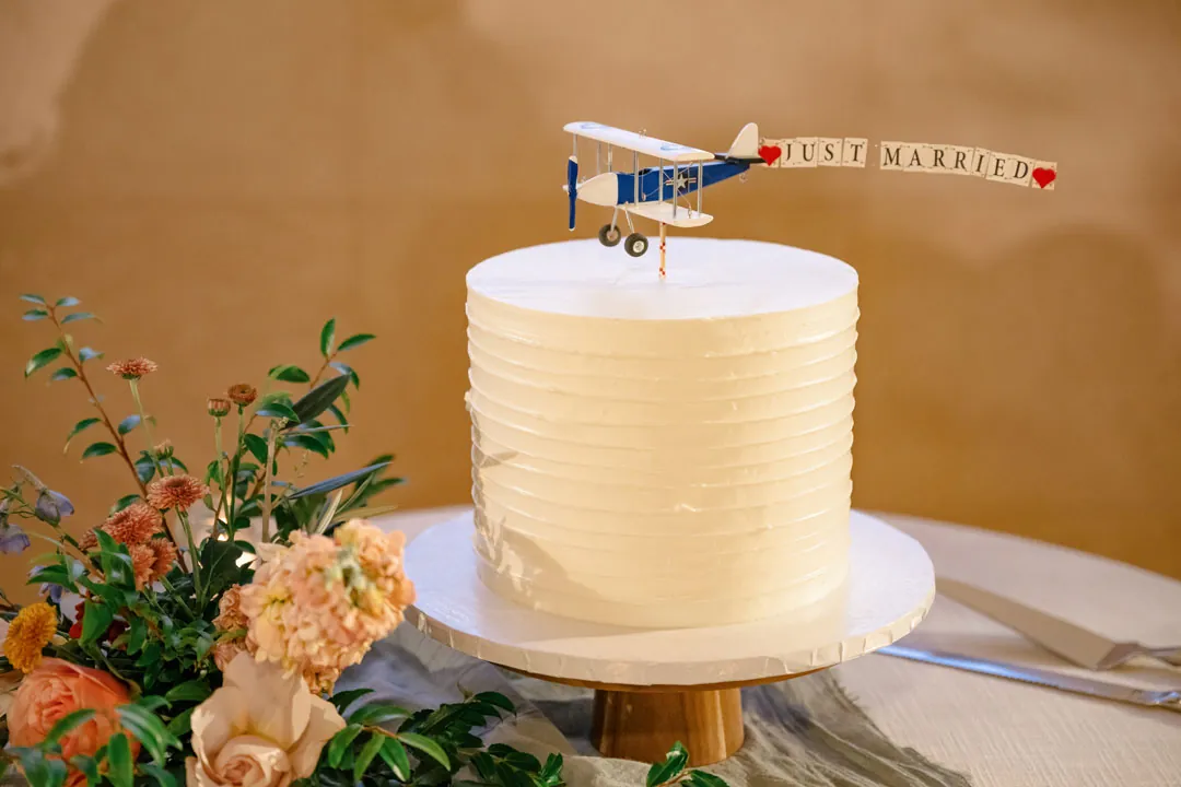 Small white cake with a model airplane topper