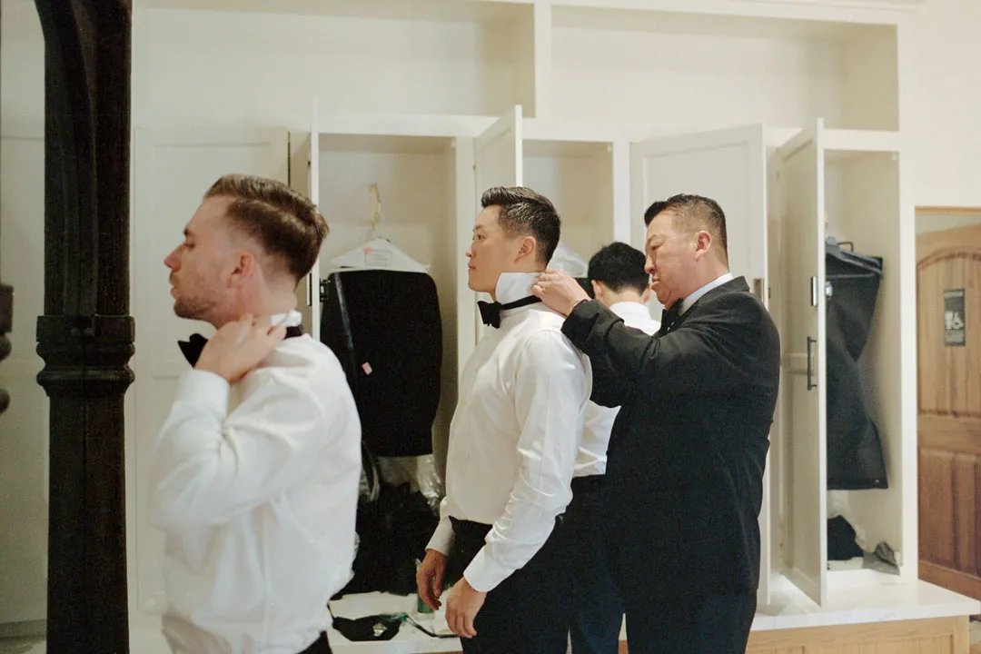 Groomsmen adjusting jackets while getting ready