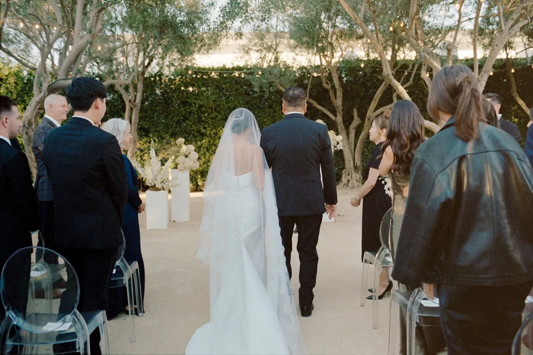 Bride walking down the aisle beside an escort