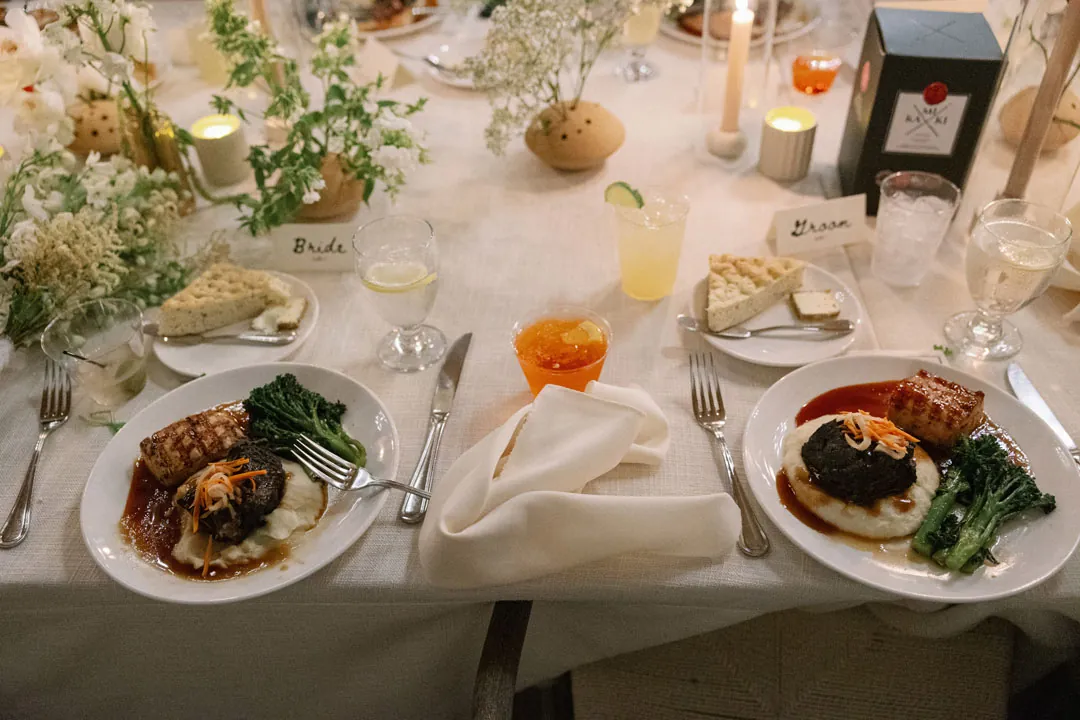 Dinner plates and drinks among reception table place settings