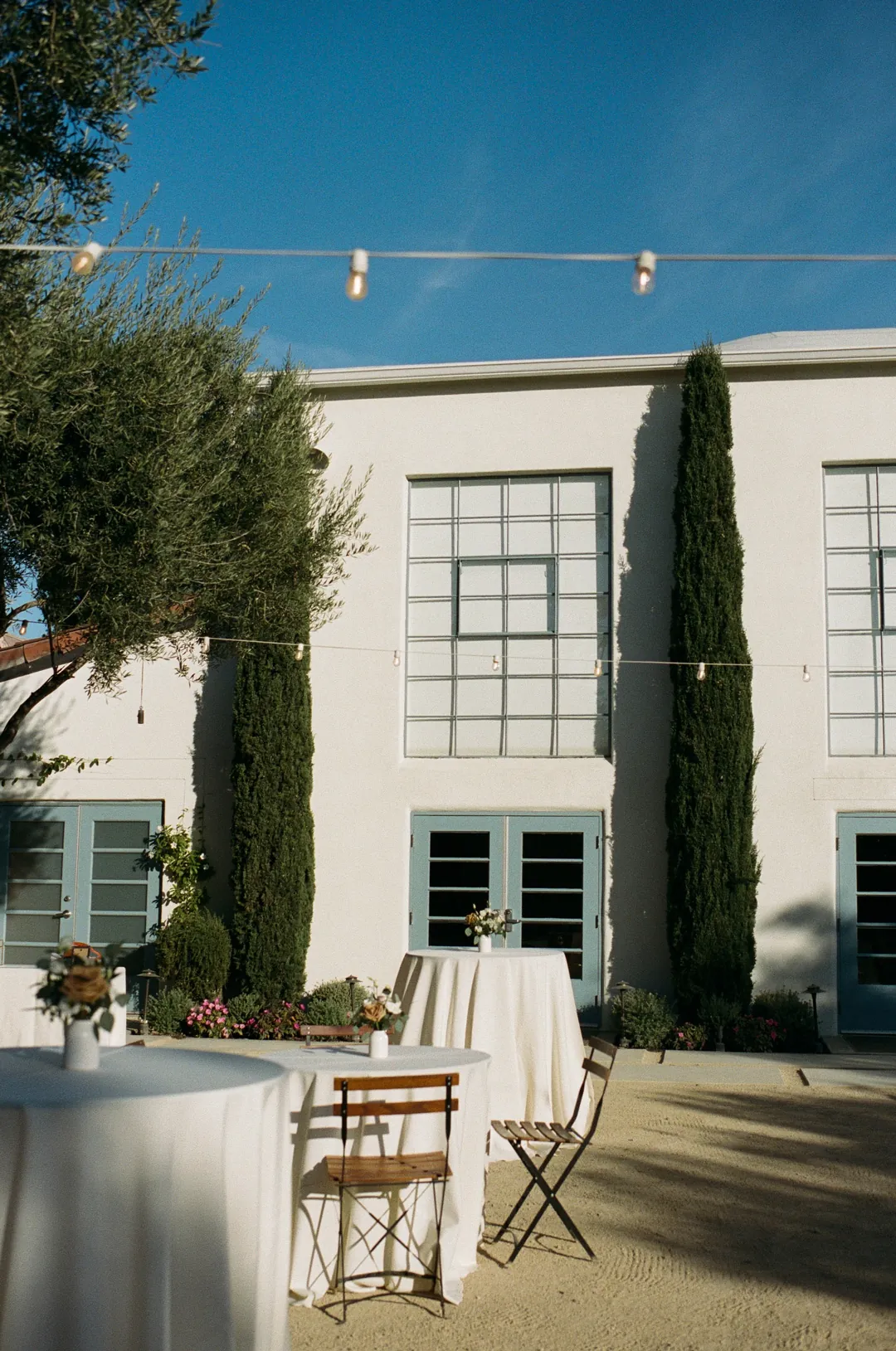 A white linen cocktail table stands beside the reception-hall doors.