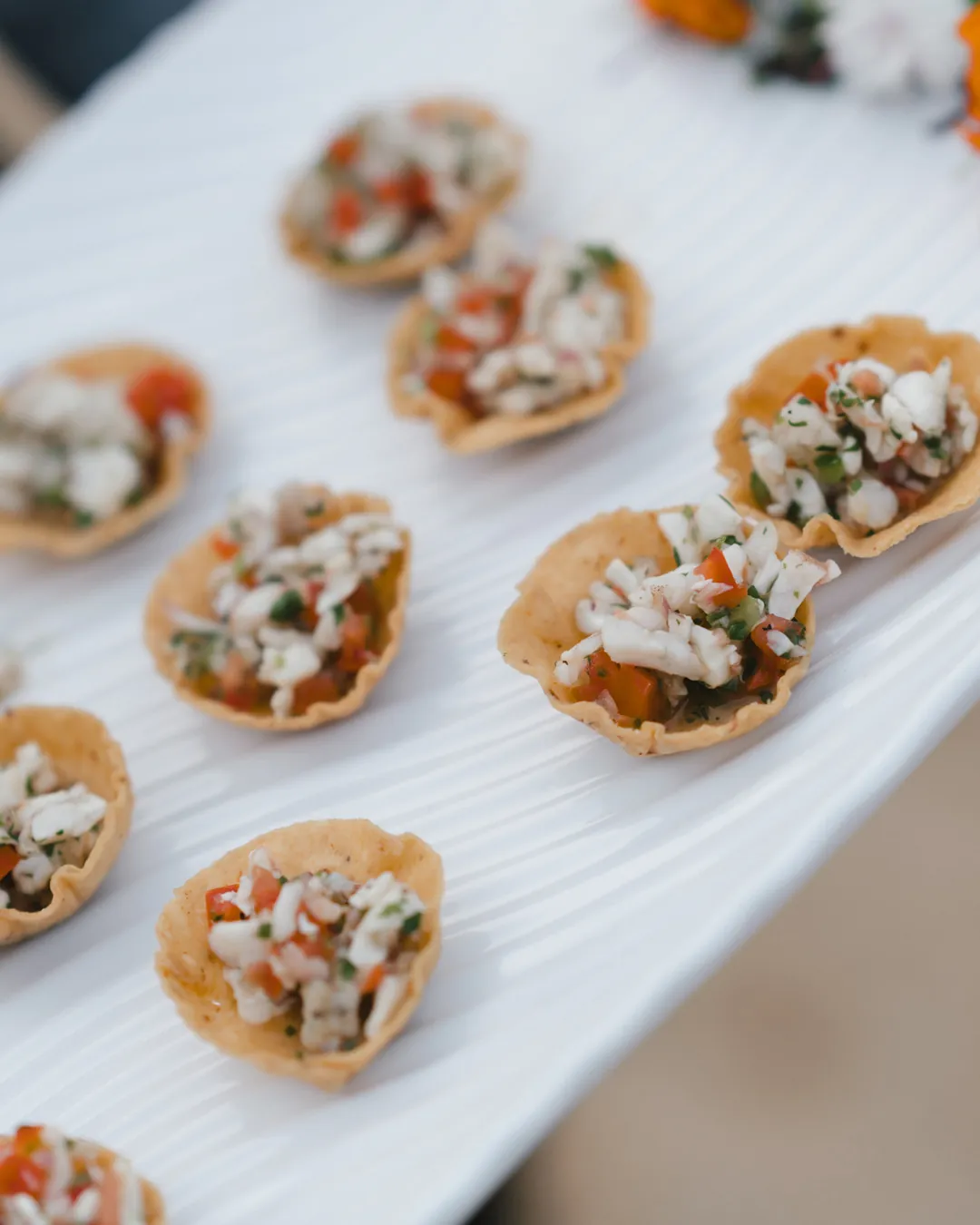 Small appetizers arranged on a white serving platter.