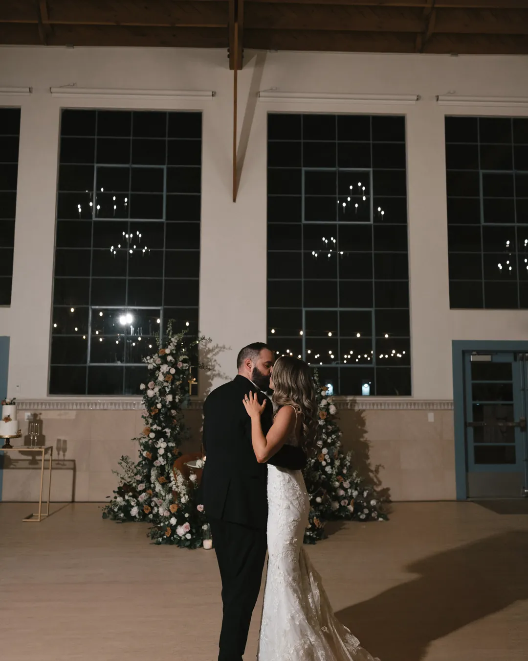 Couple sharing their first dance in the evening reception hall.