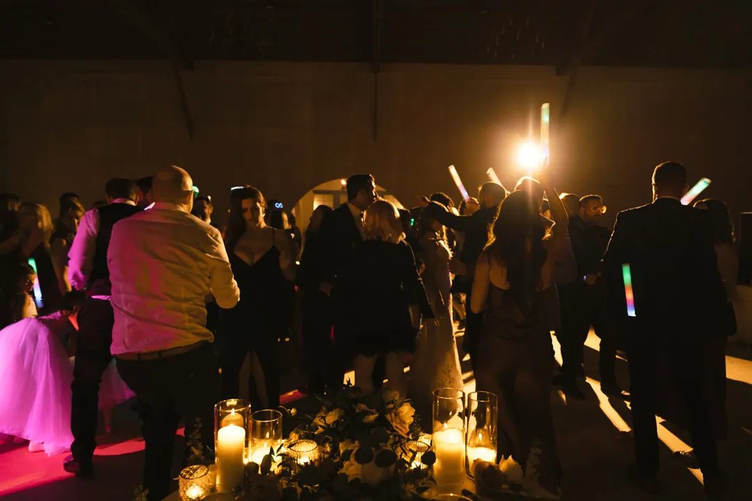 Reception guests dancing together in the evening.