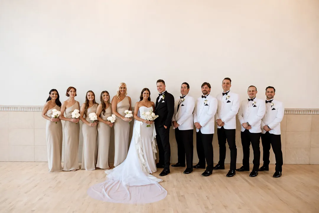 Wedding party posing together in a bright room