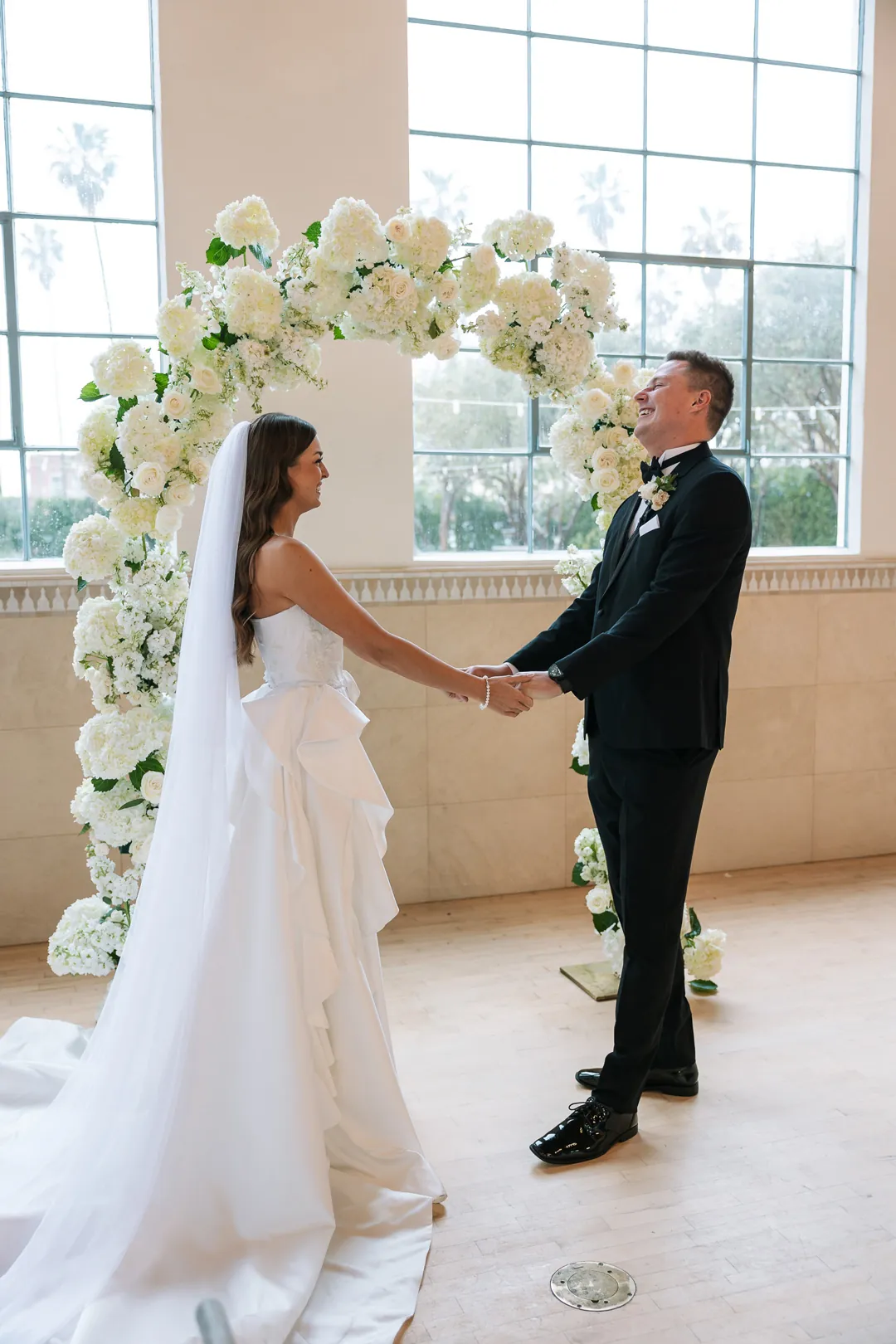 Bride and groom holding hands during their first look