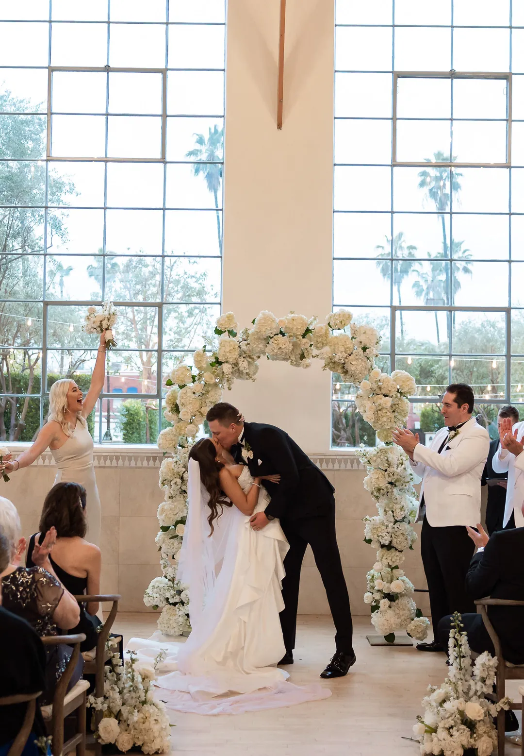 Groom dipping and kissing the bride at the ceremony