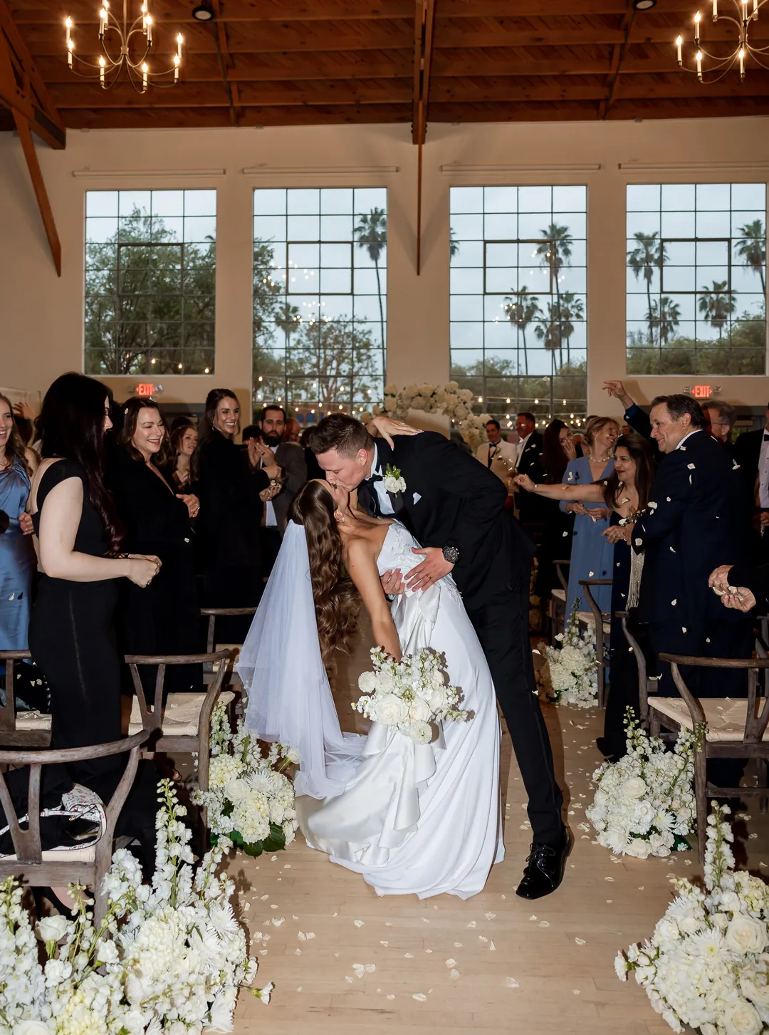 Groom dipping the bride along the ceremony aisle