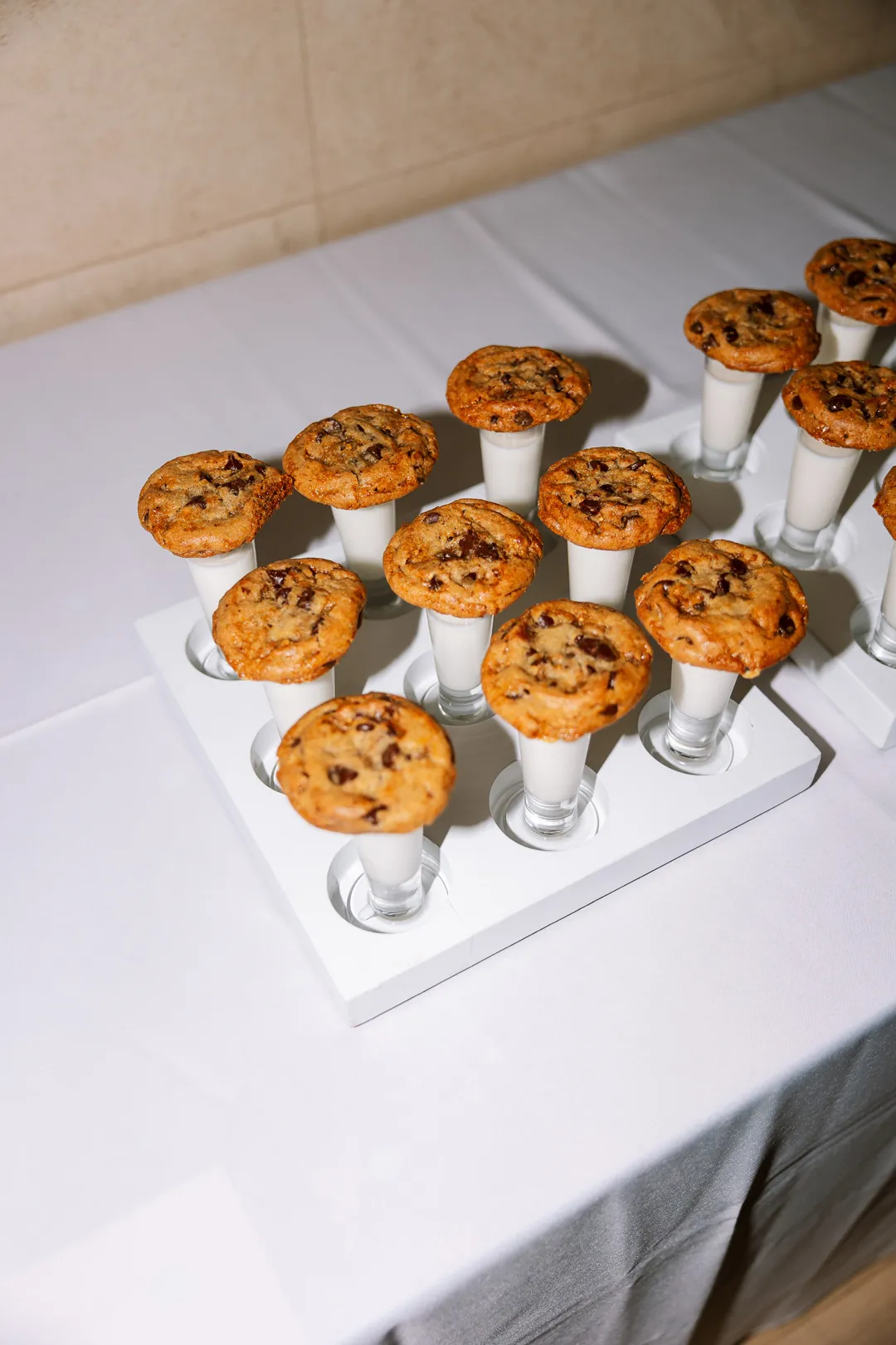 Small cookies displayed above individual milk glasses