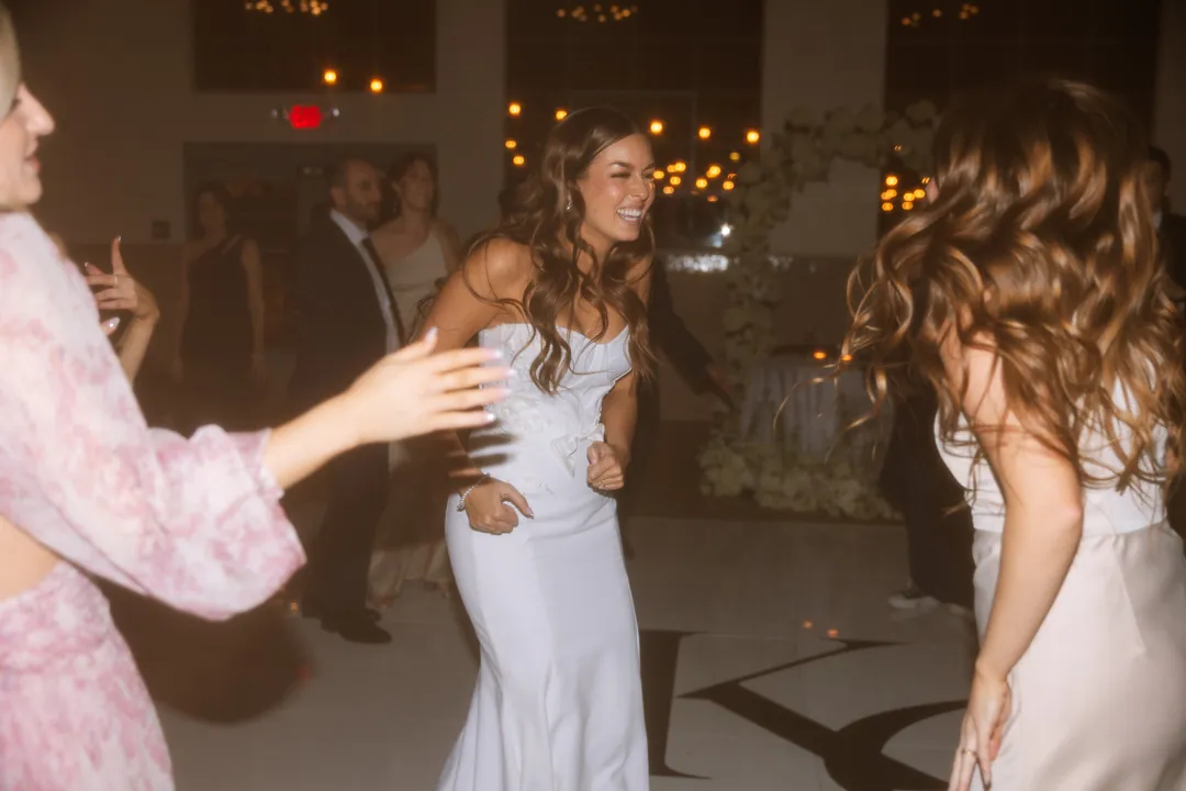 Bride dancing with wedding guests at the reception
