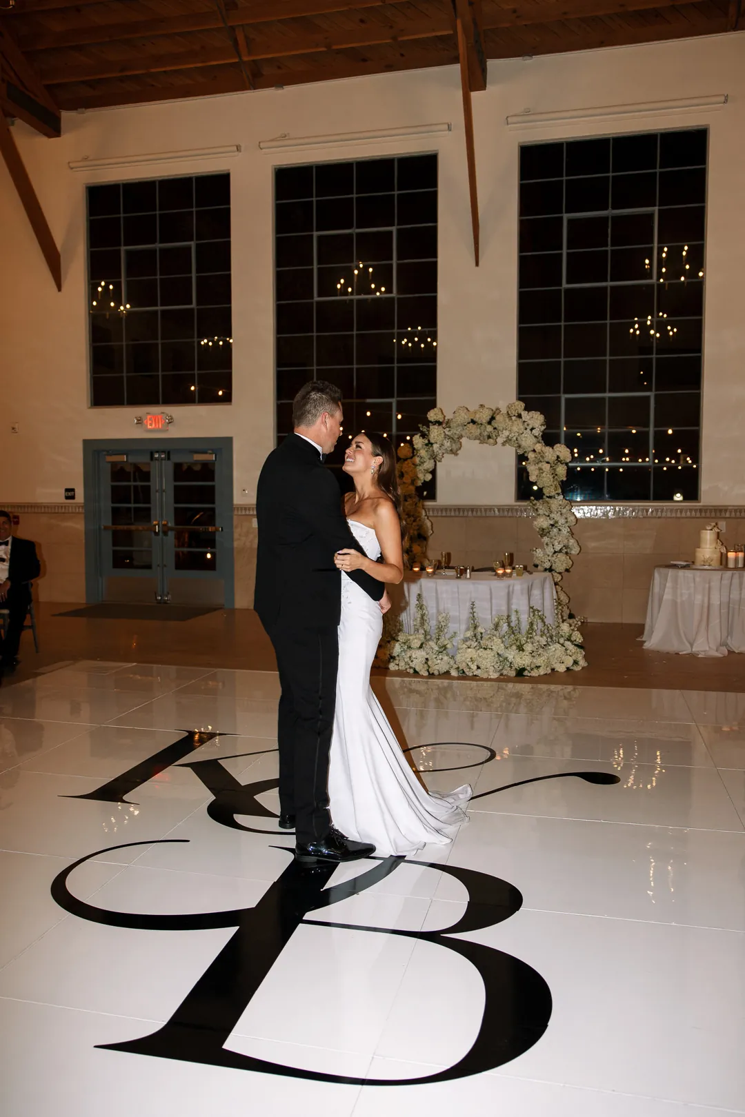 Bride and groom dancing on a white monogrammed floor