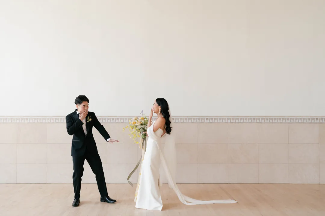 Bride and groom smiling during their first look