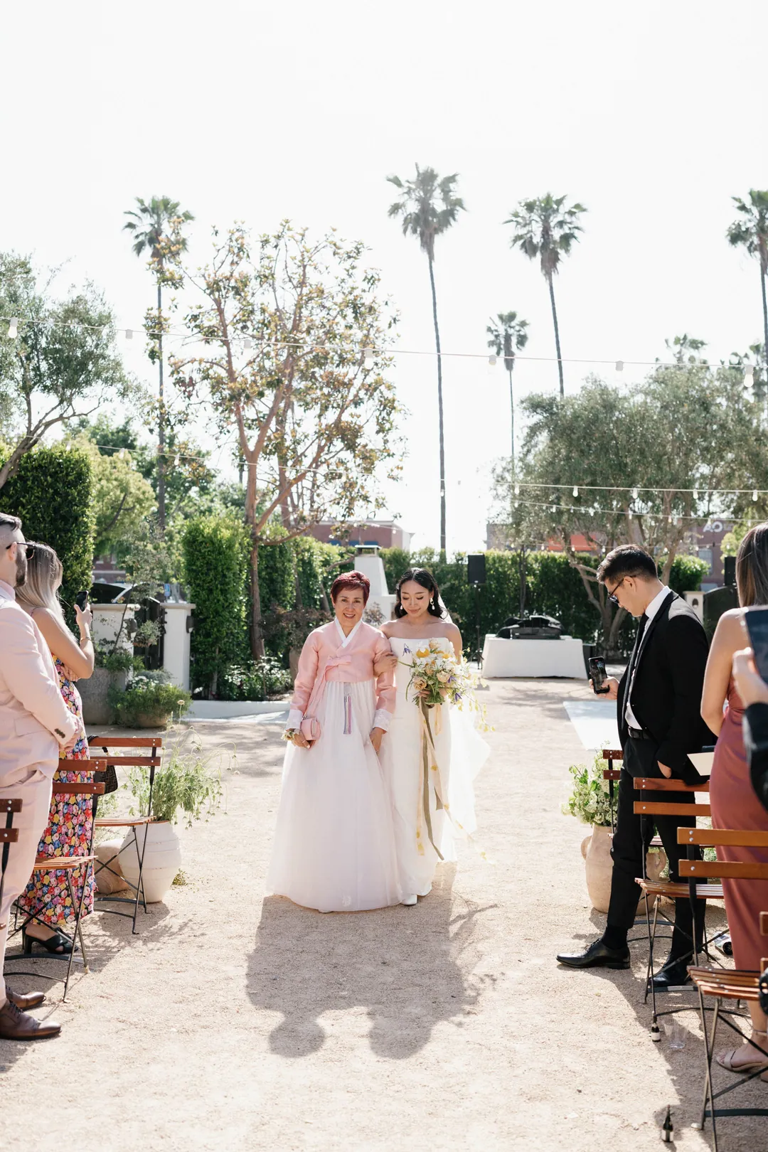 Bride walking down the ceremony aisle with an escort