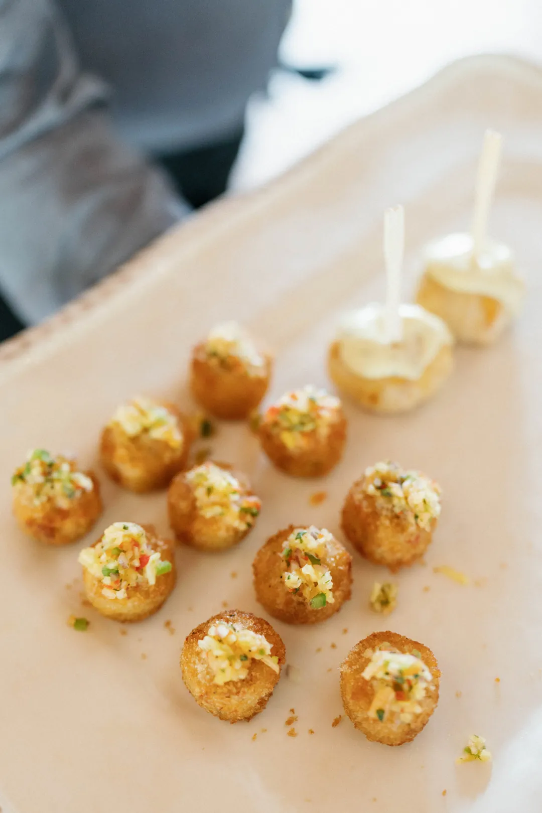 Golden appetizers and small drinks on a serving tray