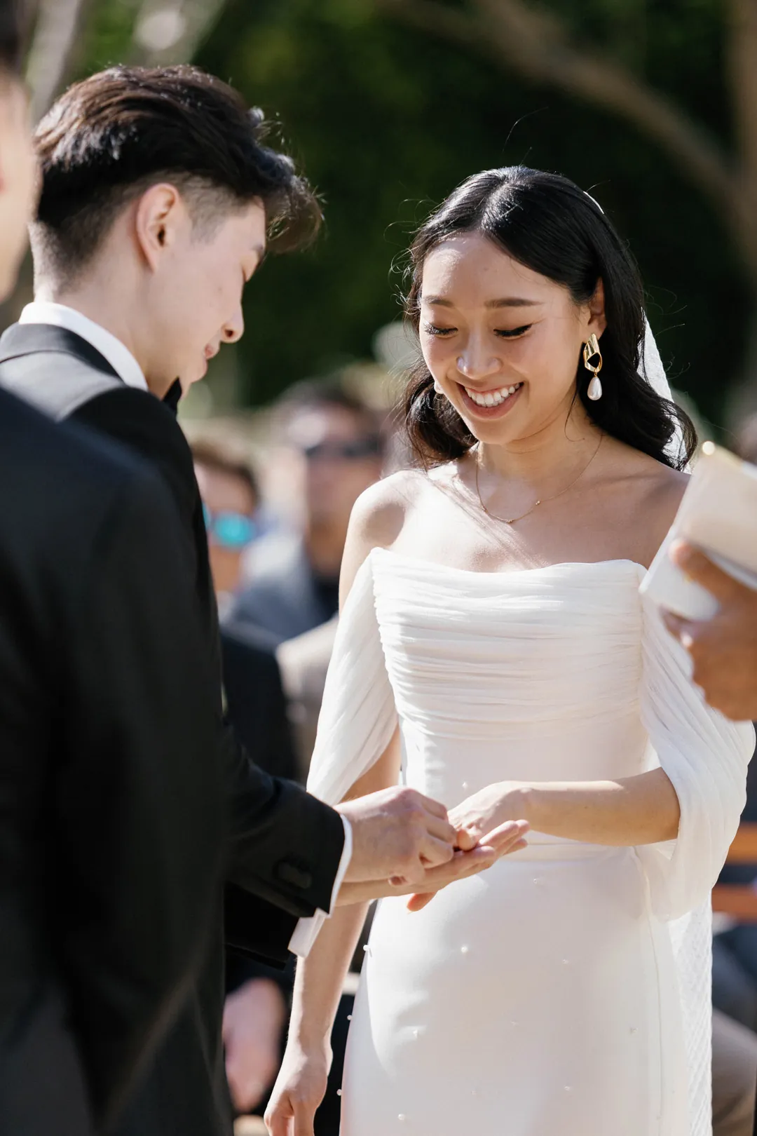Bride smiling while holding the groom's hands