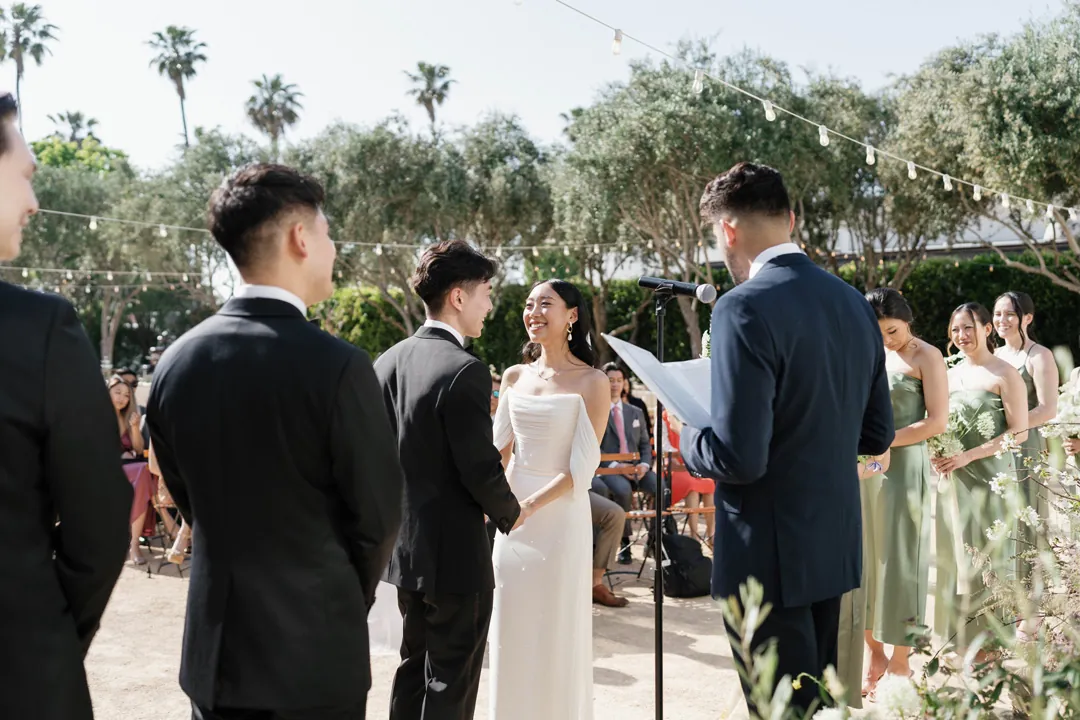 Bride facing the groom and officiant during the ceremony
