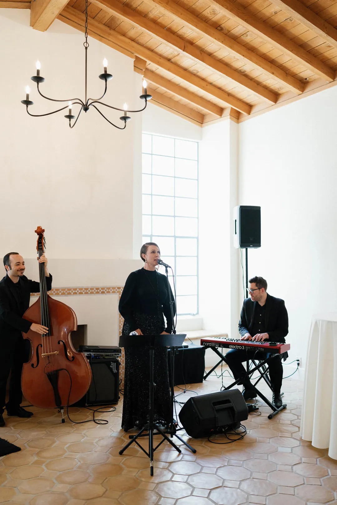 Musicians performing with an upright bass and keyboard indoors