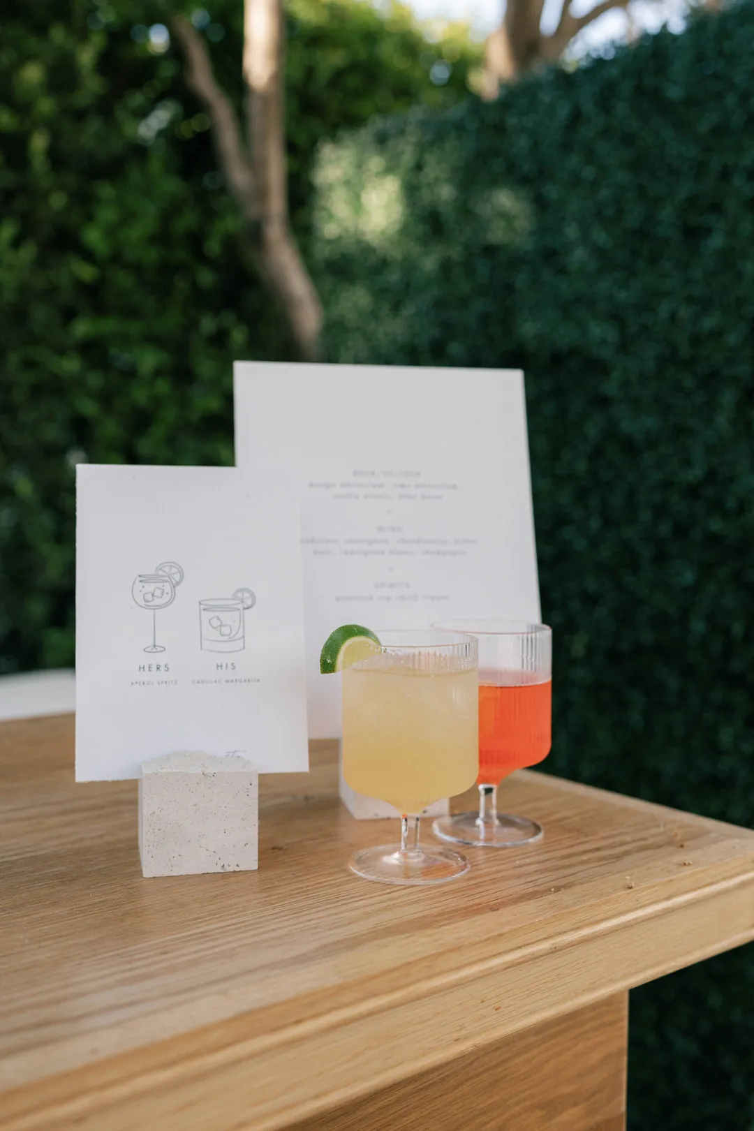 Cocktail glasses beside a framed drinks menu on the bar