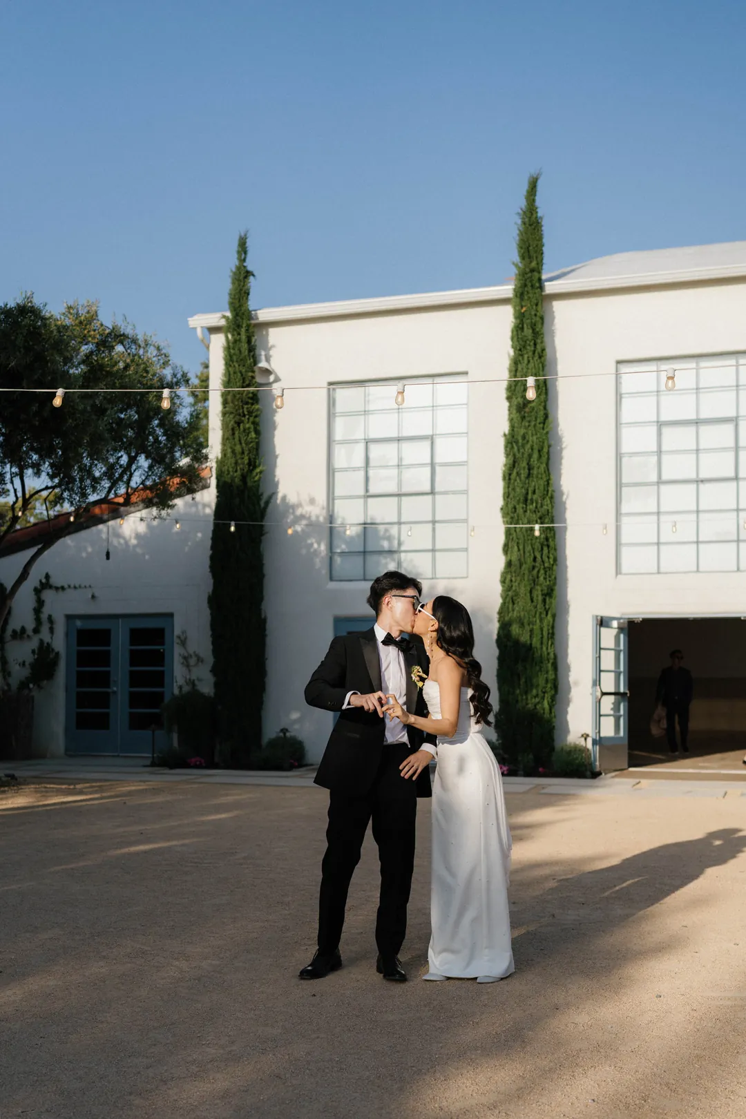 Bride and groom embracing outside the reception hall