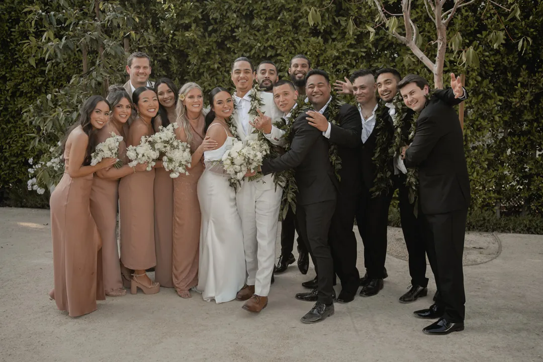Bride and groom posing with their wedding party