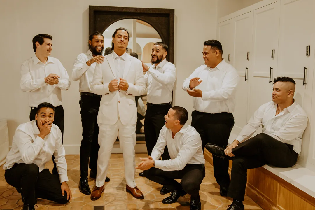 Groom and groomsmen getting ready in white shirts