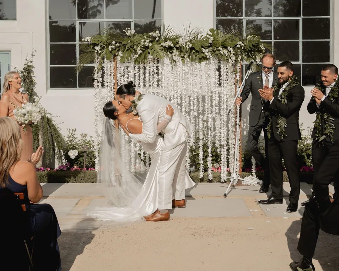 Groom dipping and kissing the bride at the ceremony