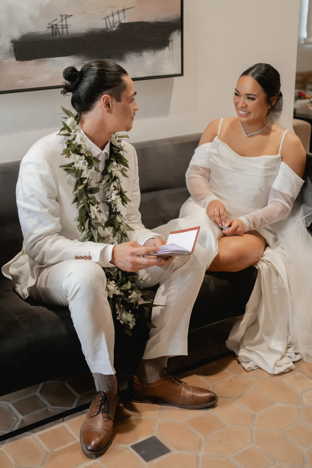 Bride and groom chatting on a lounge sofa