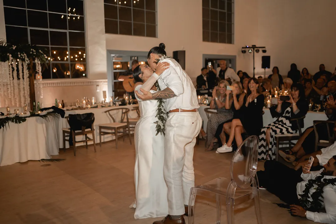The couple embraces on the reception dance floor.