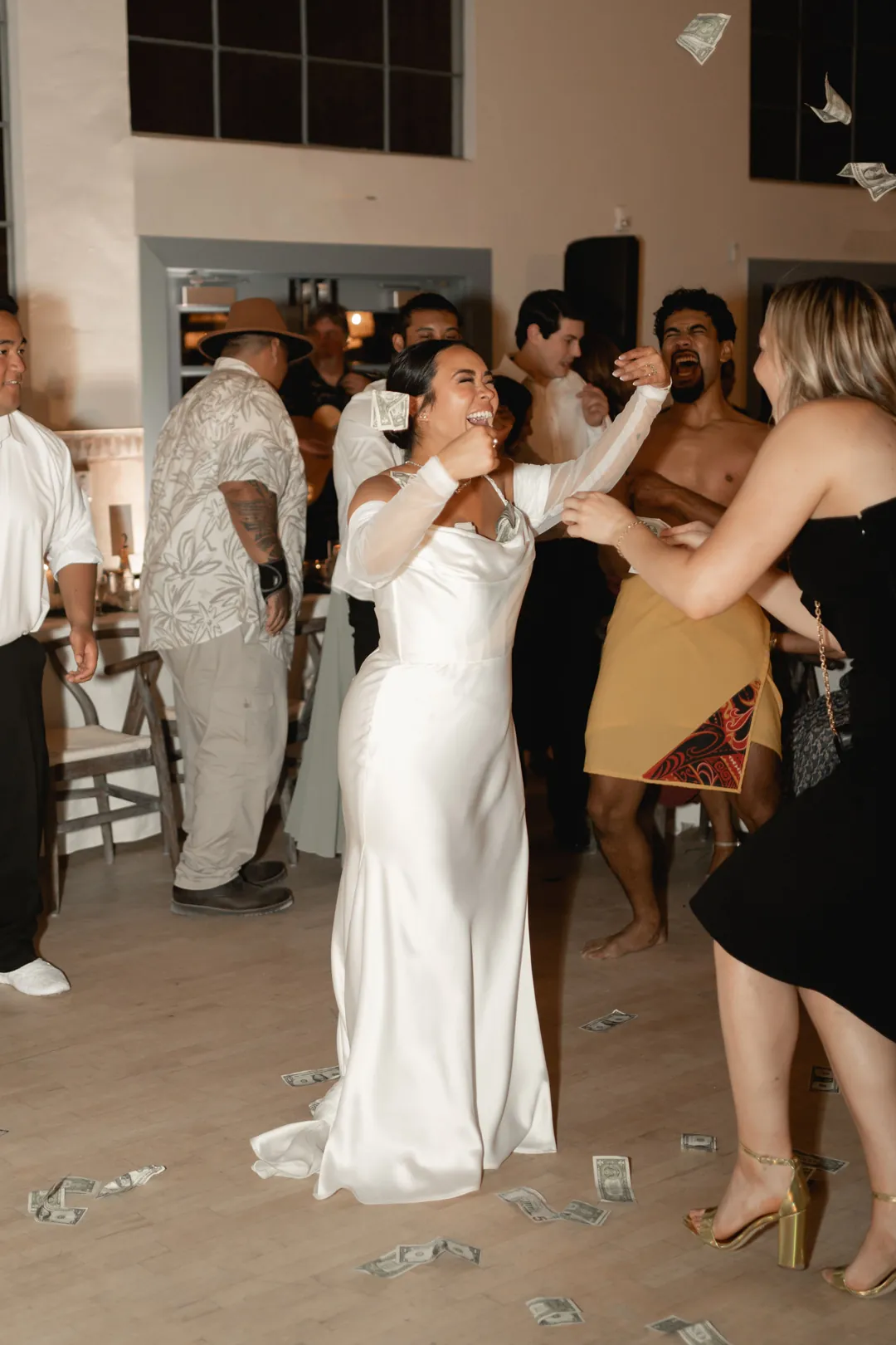 The bride dances among reception guests.