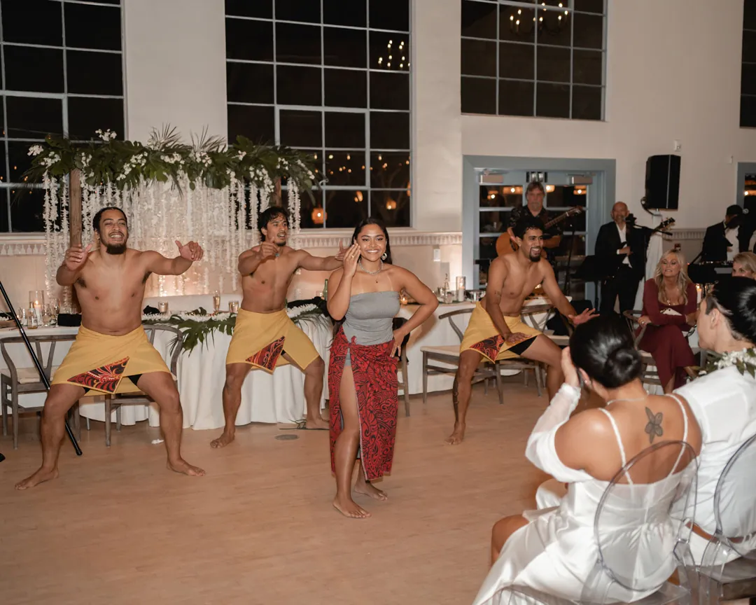A group of performers dances in the reception hall.