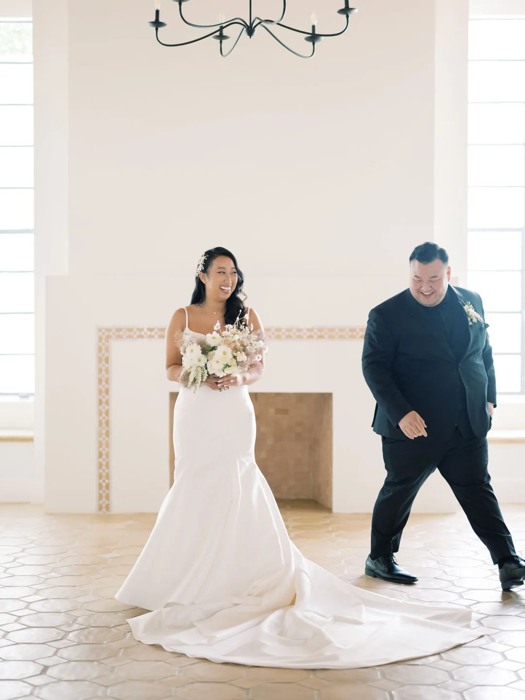 The couple laughs together in the covered courtyard.