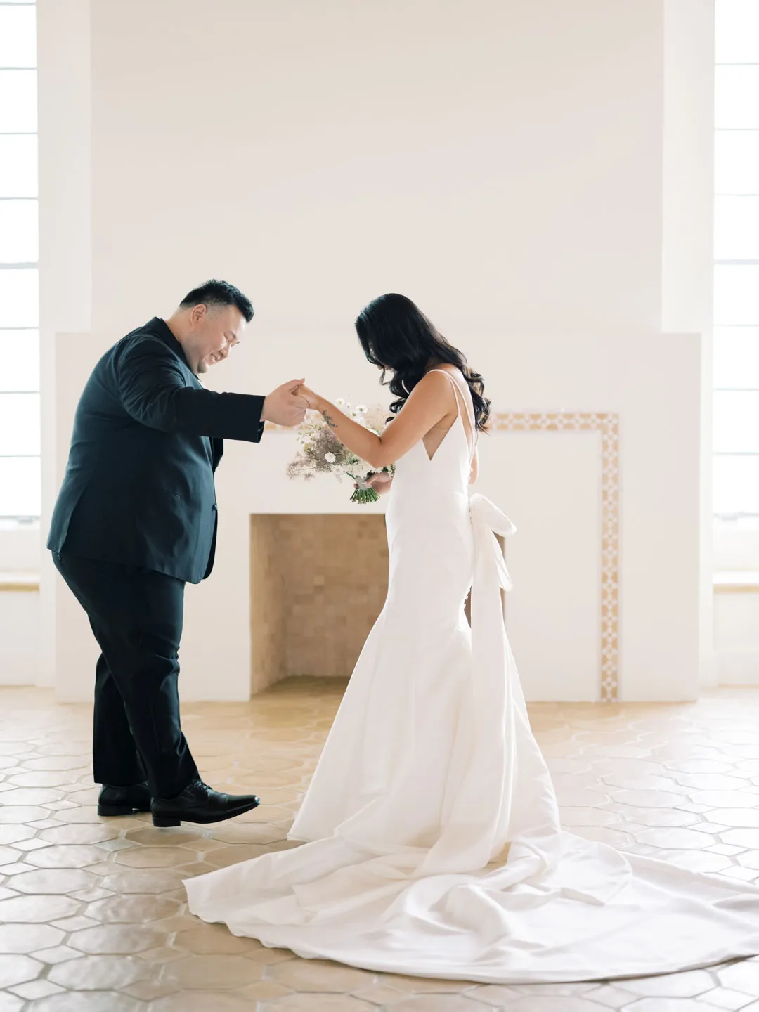 The couple touches hands before the ceremony.