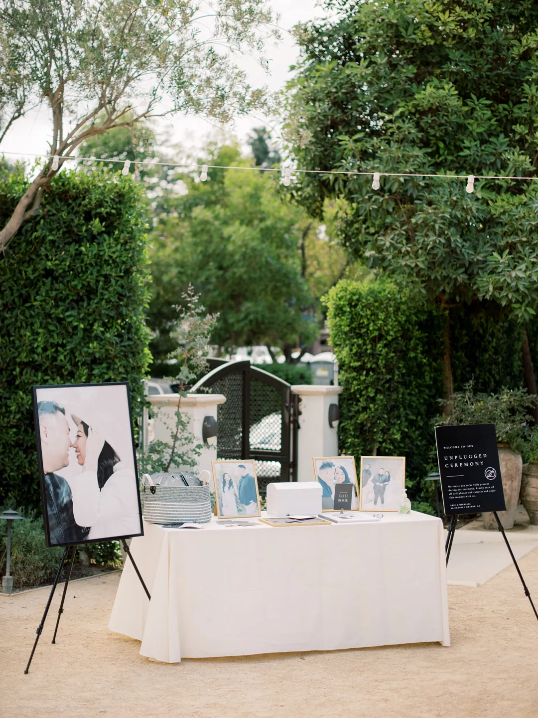A welcome table stands beside courtyard display boards.