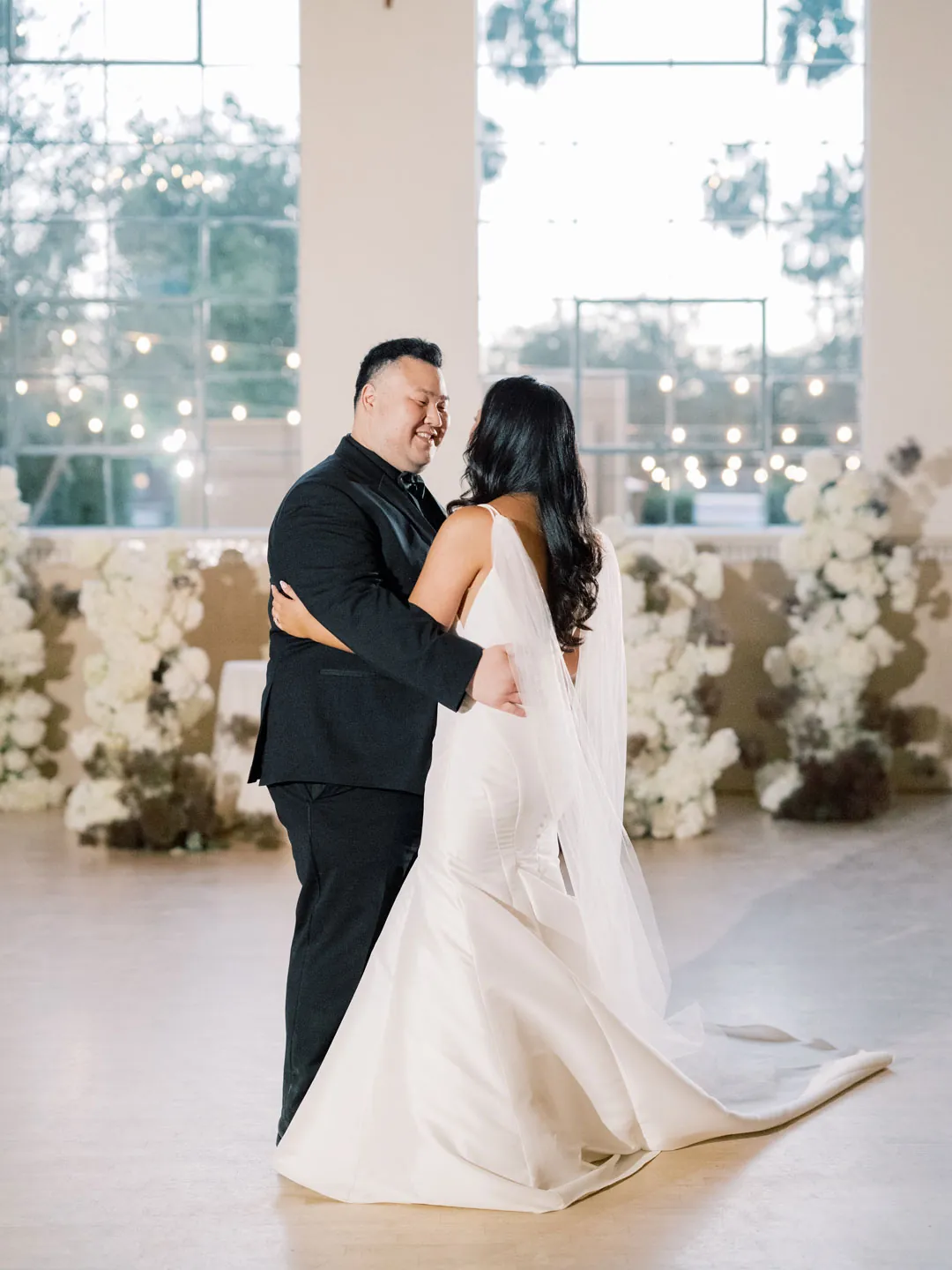 Bride and groom dancing together in the reception hall
